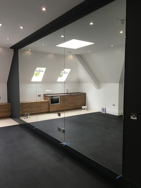 Frameless glass partition in loft conversion by Kingston upon Thames glaziers