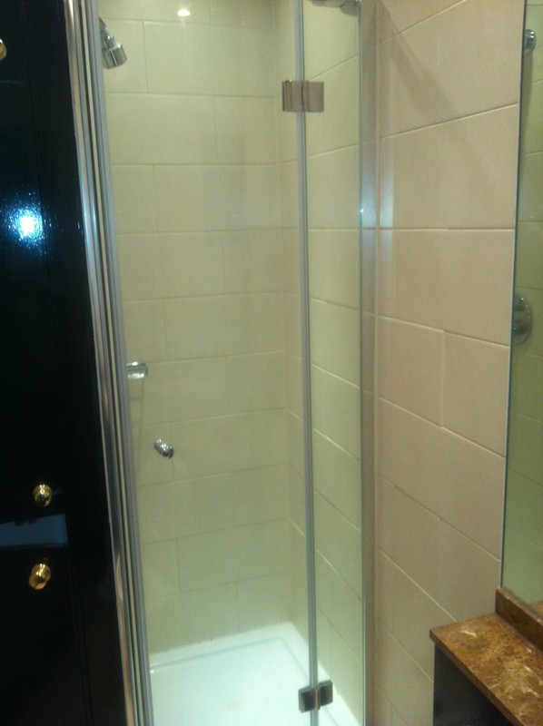 Frameless glass shower enclosure with chrome fittings in Kingston upon Thames