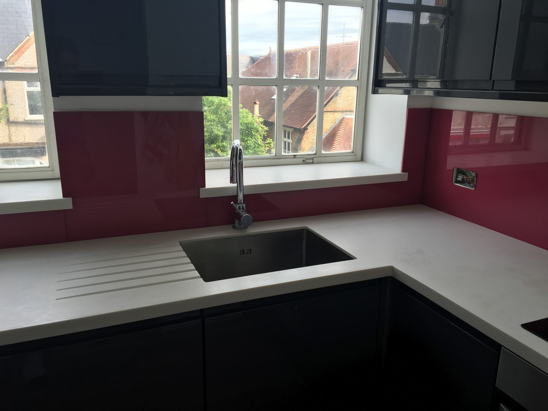 Deep plum coloured glass splashback in modern Kingston upon Thames kitchen