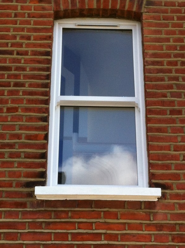 uPVC sash window on Victorian red brick house in Kingston upon Thames